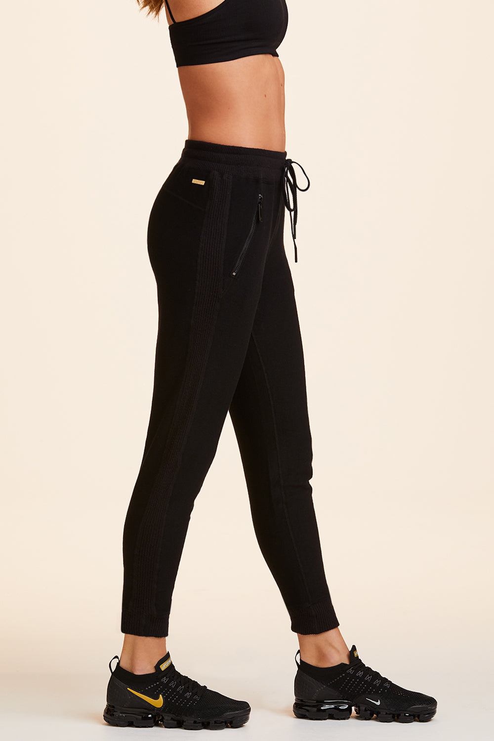 Side view of Alala Women's Luxury Athleisure black sweatpant