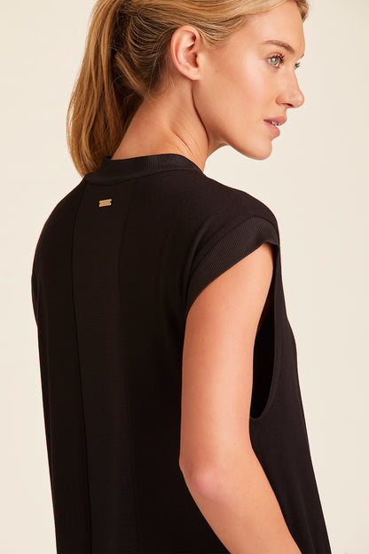 Zoomed in view of back of Alala Luxury Women's Athleisure plie dress in black