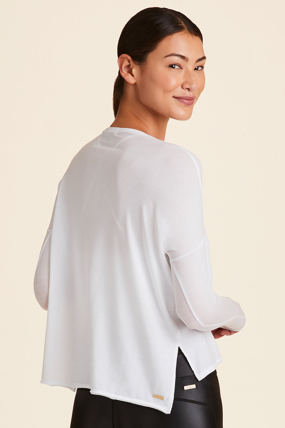 3/4 back view of Alala Women's Luxury Athleisure white long-sleeve super soft tee