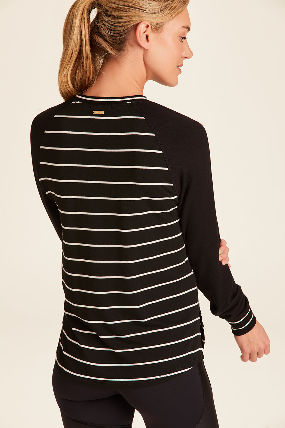 Back view of Alala Luxury Women's Athleisure breeze sweatshirt in black and white