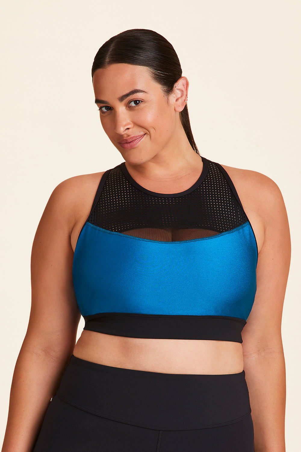 Front view of Alala Women's Luxury Athleisure black and teal sports bra with mesh detail in plus size
