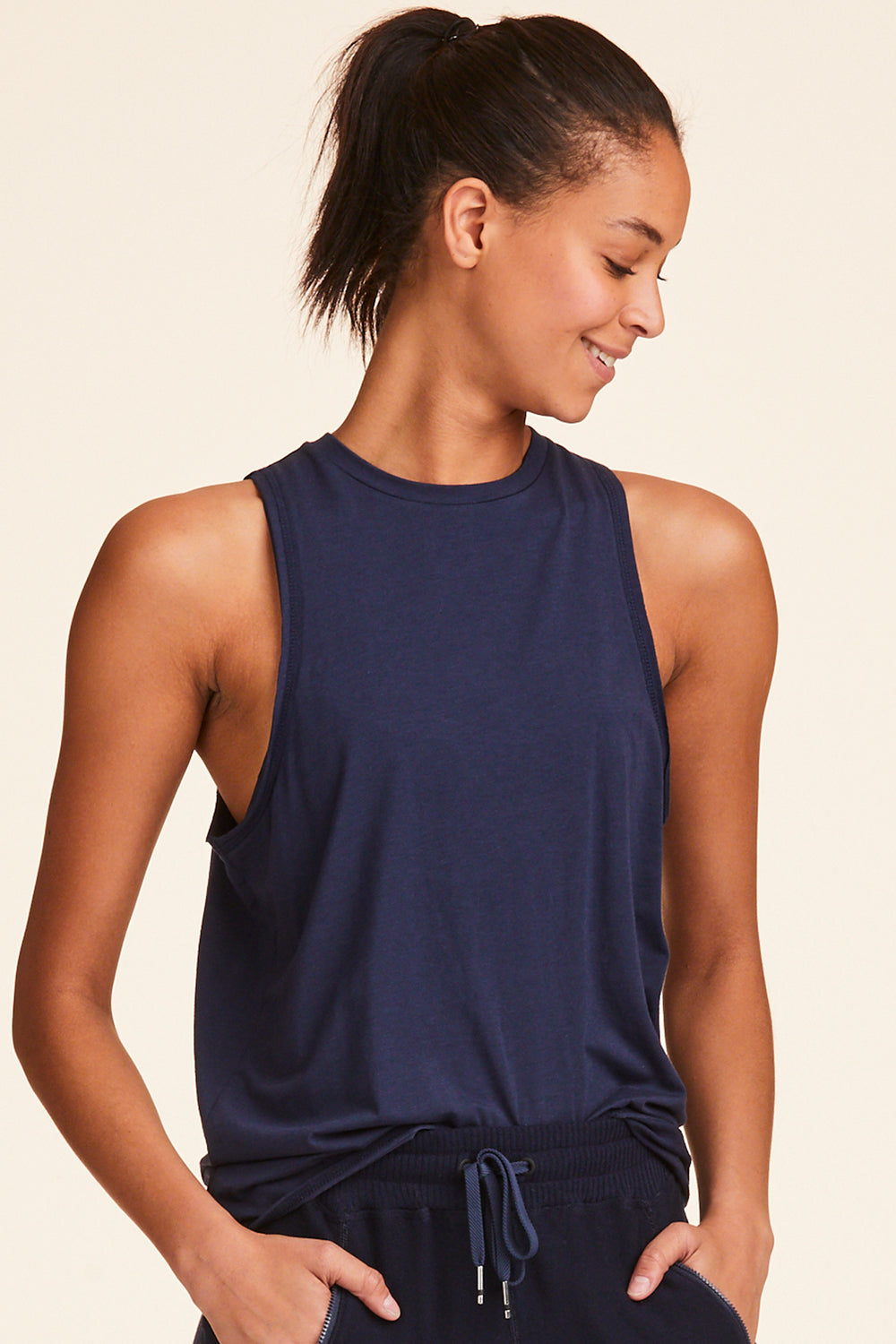 Front view of Alala Women's Luxury Athleisure navy tank with keyhole opening on back