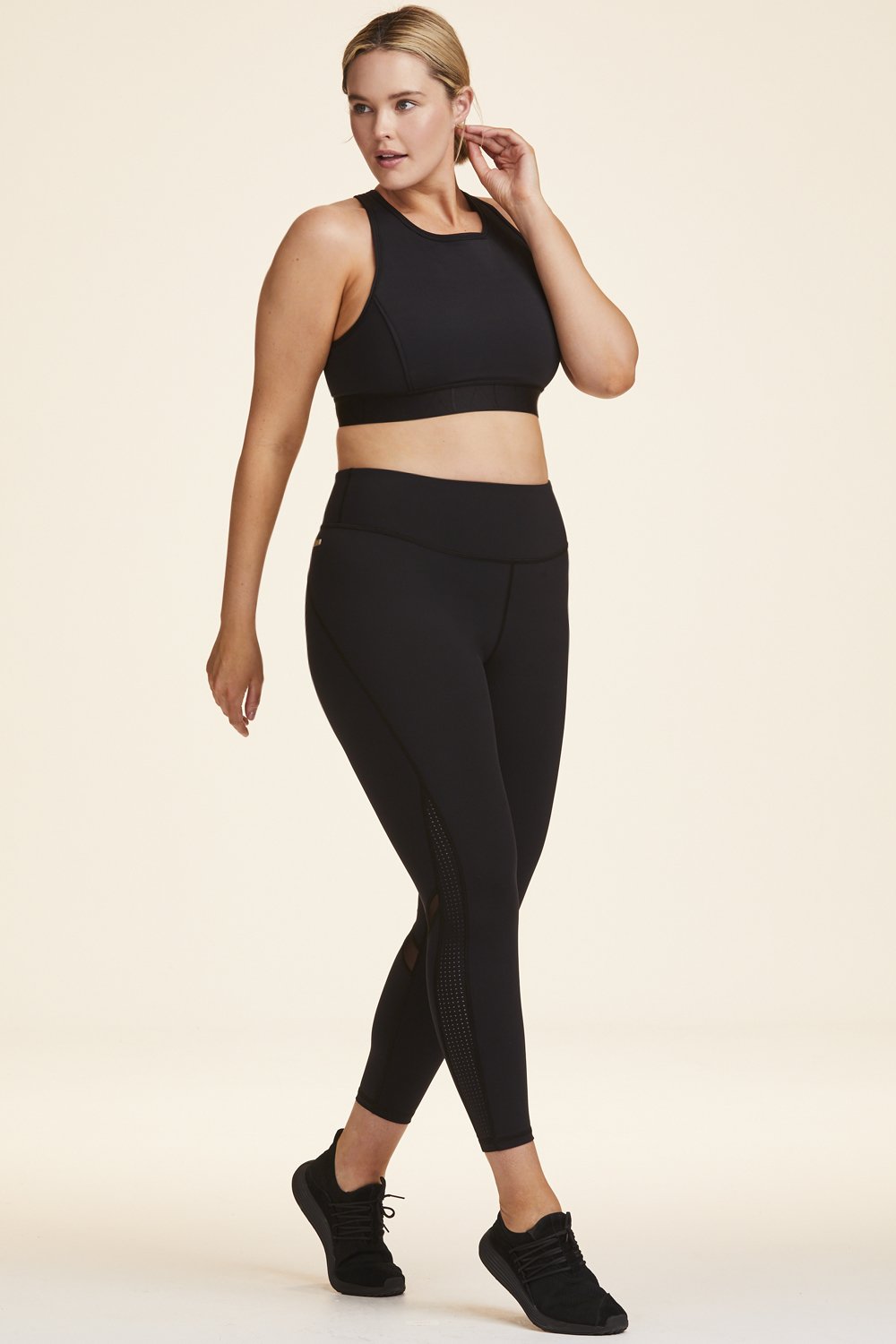 Side view of Alala Women's Luxury Athleisure black tight with minimal mesh detail in plus size