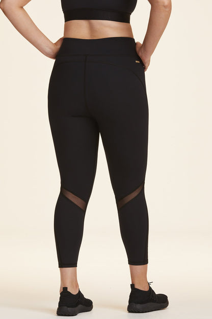 Back view of Alala Women's Luxury Athleisure black tight with minimal mesh detail