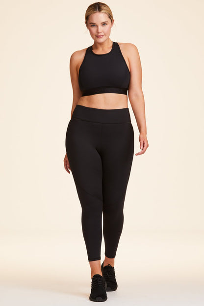 Front view of Alala Women's Luxury Athleisure black tight with mesh paneling on back of knees