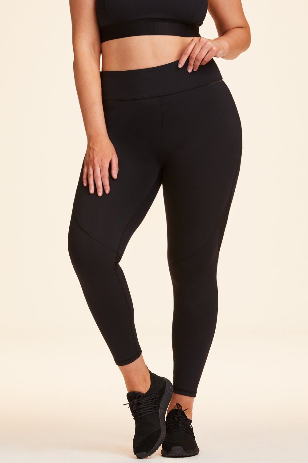 Front view of Alala Women's Luxury Athleisure black tight with mesh paneling on back of knees