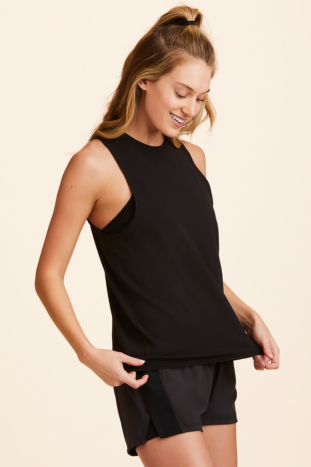 3/4 front view of Alala Women's Luxury Athleisure black tank with keyhole opening on back