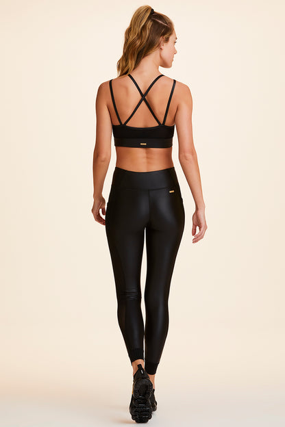 Back view of Alala Women's Luxury Athleisure shiny black tight with sheer ribbed detail