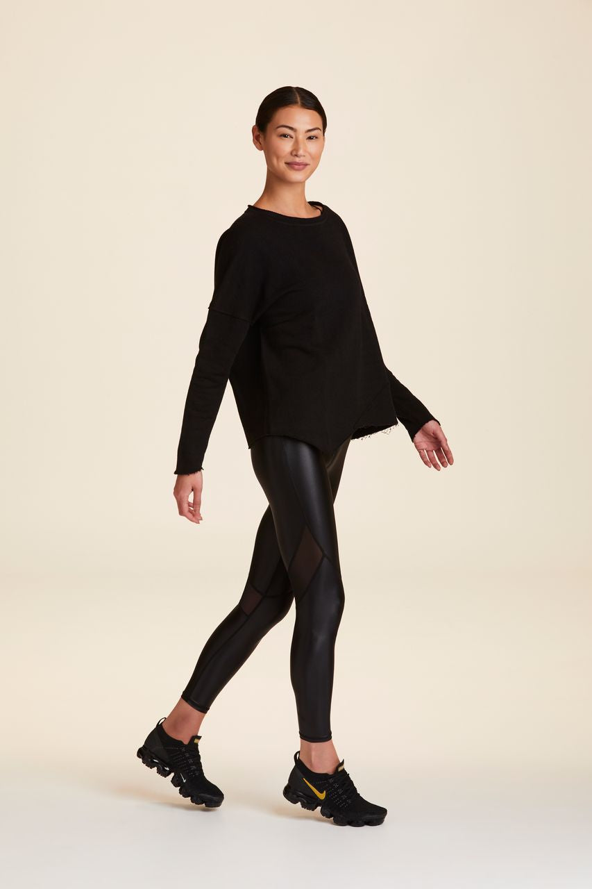 3/4 view of Alala Women's Luxury Athleisure black sweatshirt with distressed details on seams