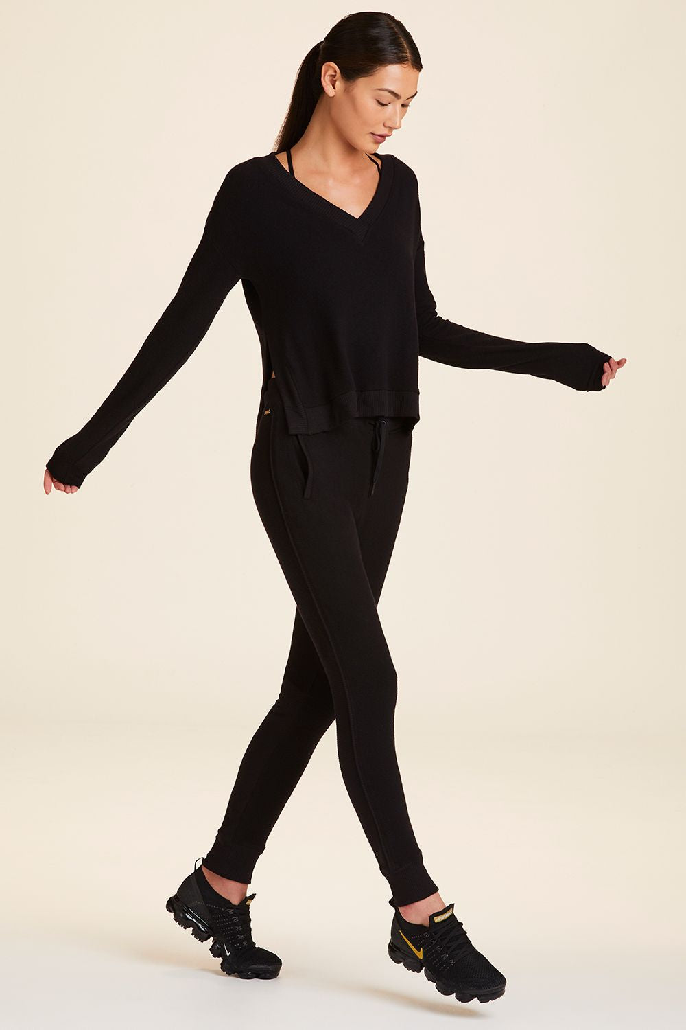 Full body side view of Alala Women's Luxury Athleisure wander sweatshirt in black