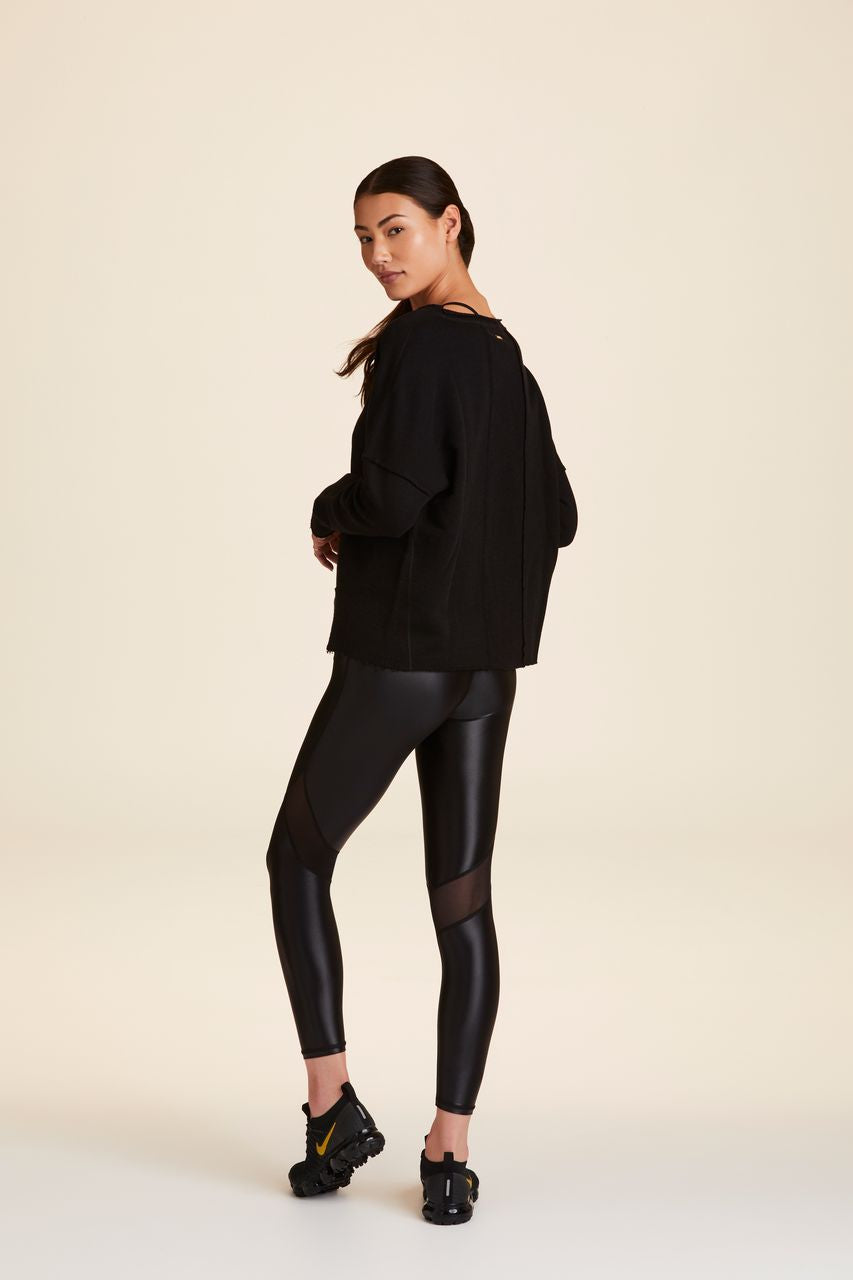3/4 back view of Alala Women's Luxury Athleisure black sweatshirt with distressed details on seams